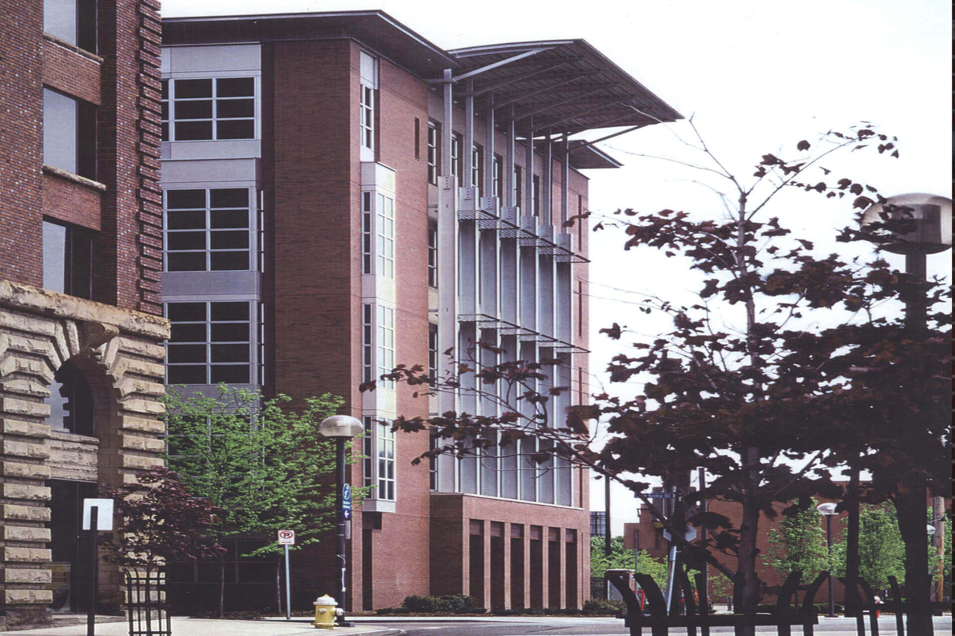 A modern brick building with large windows and a sloped roof.