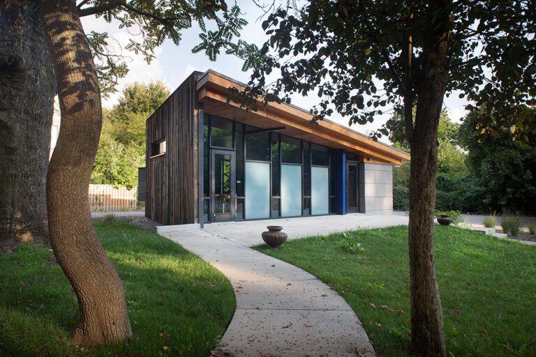 Modern house with large windows and path.