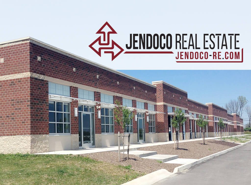 Red brick commercial strip with Jendoco logo